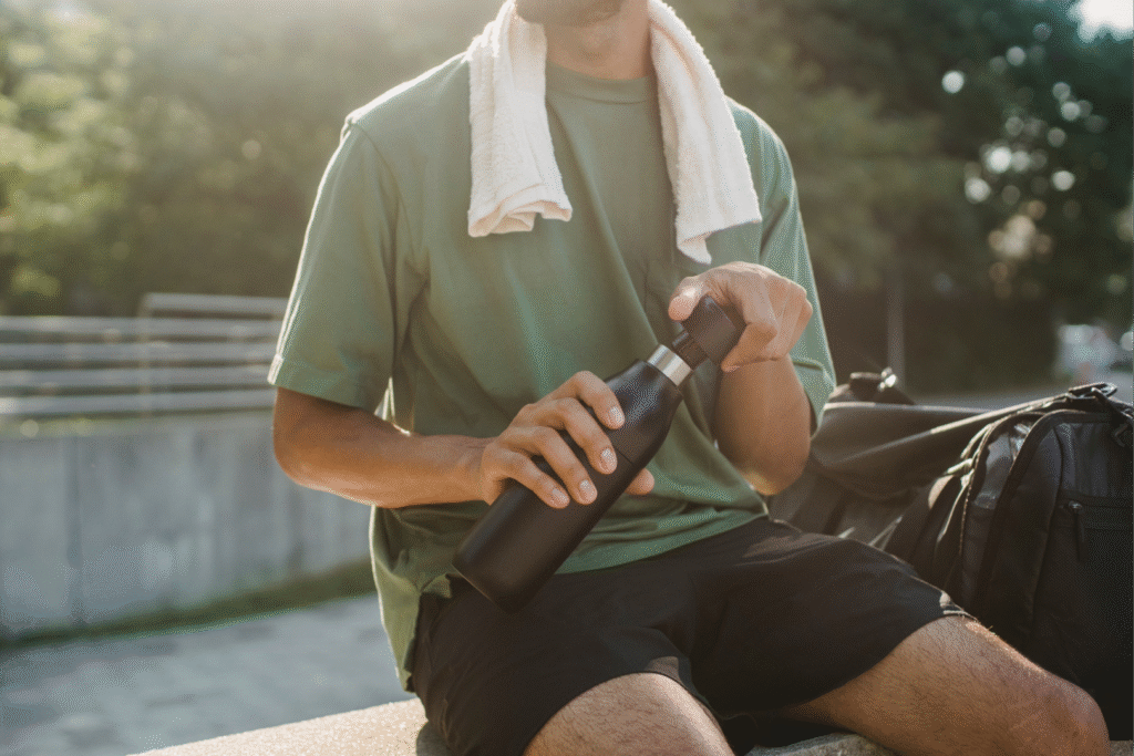 man drinking water after cardio