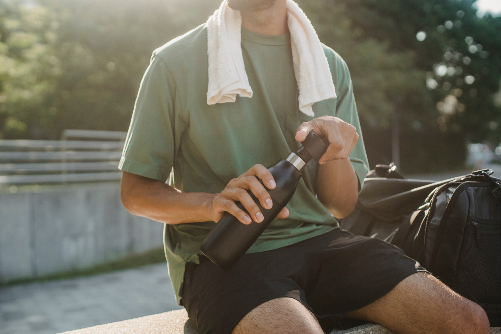 man drinking water after cardio